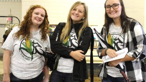 three smiling female students wearing East Campus 50th T-shirts